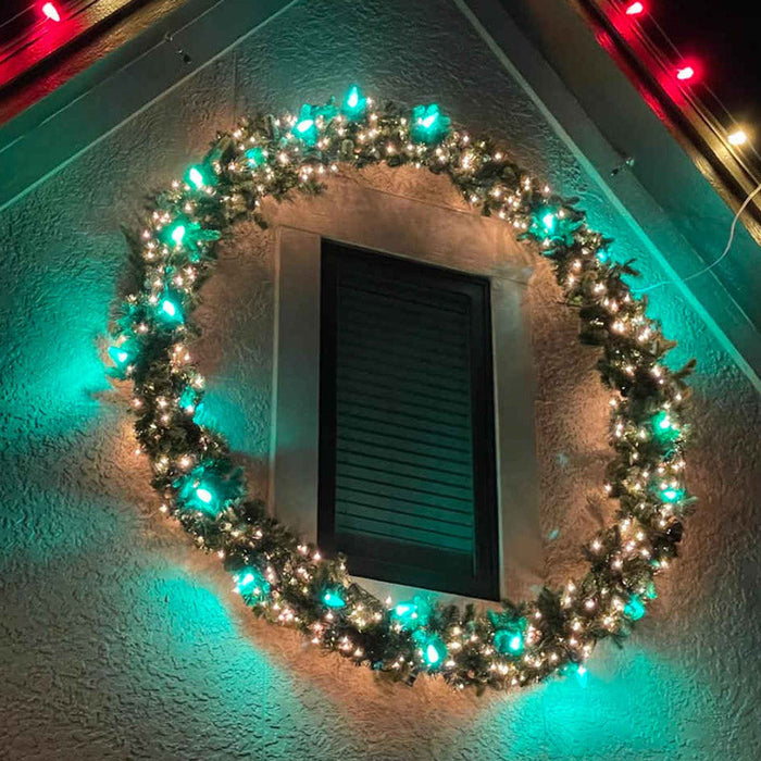 Lighted holiday wreath on a home entry