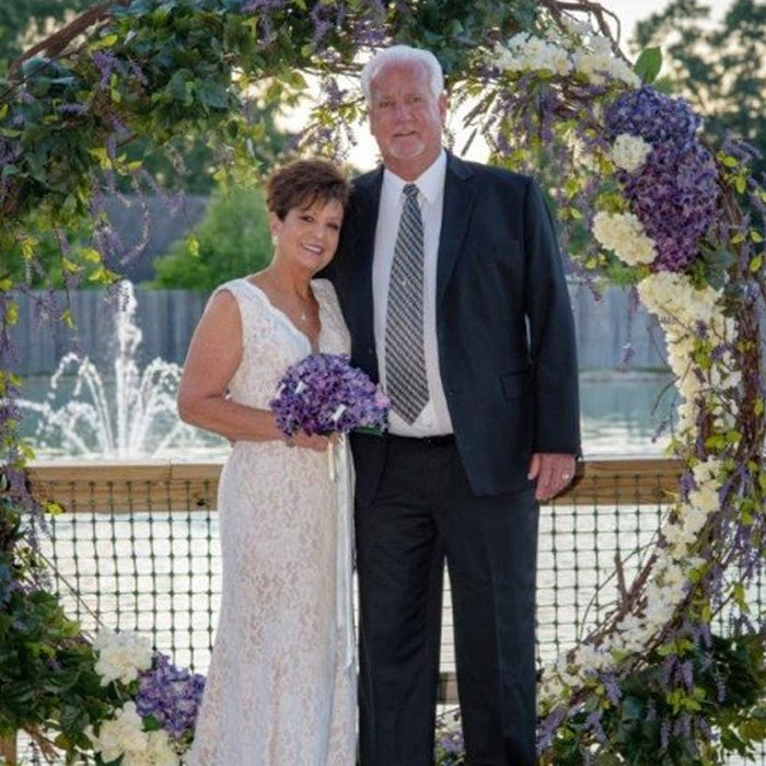 Wedding arbor wreath greenery
